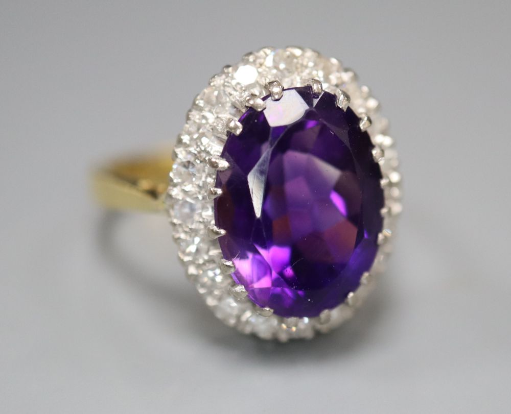 A 1970s 18ct gold, amethyst and diamond set oval cluster dress ring, size Q, gross 7.8 grams.